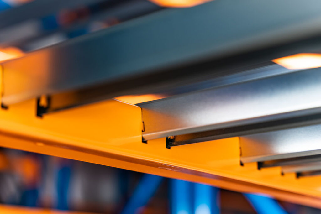 detal pomarańczowej belki regału magazynowego – fotografia przemysłowa Wrocław